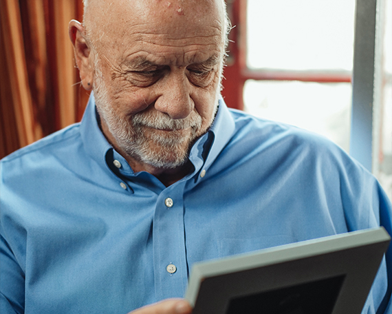 resident looking at loved one in picture frame