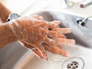 washing hands in sink