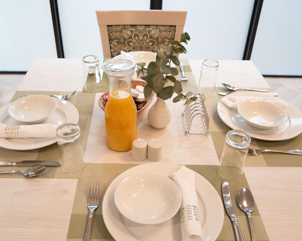 dining table setup with plates and cutlery