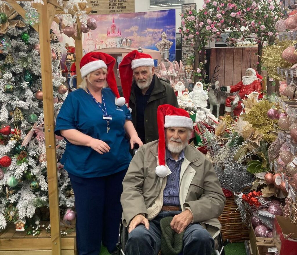 our residents on a shopping trip dressed up with santa hats