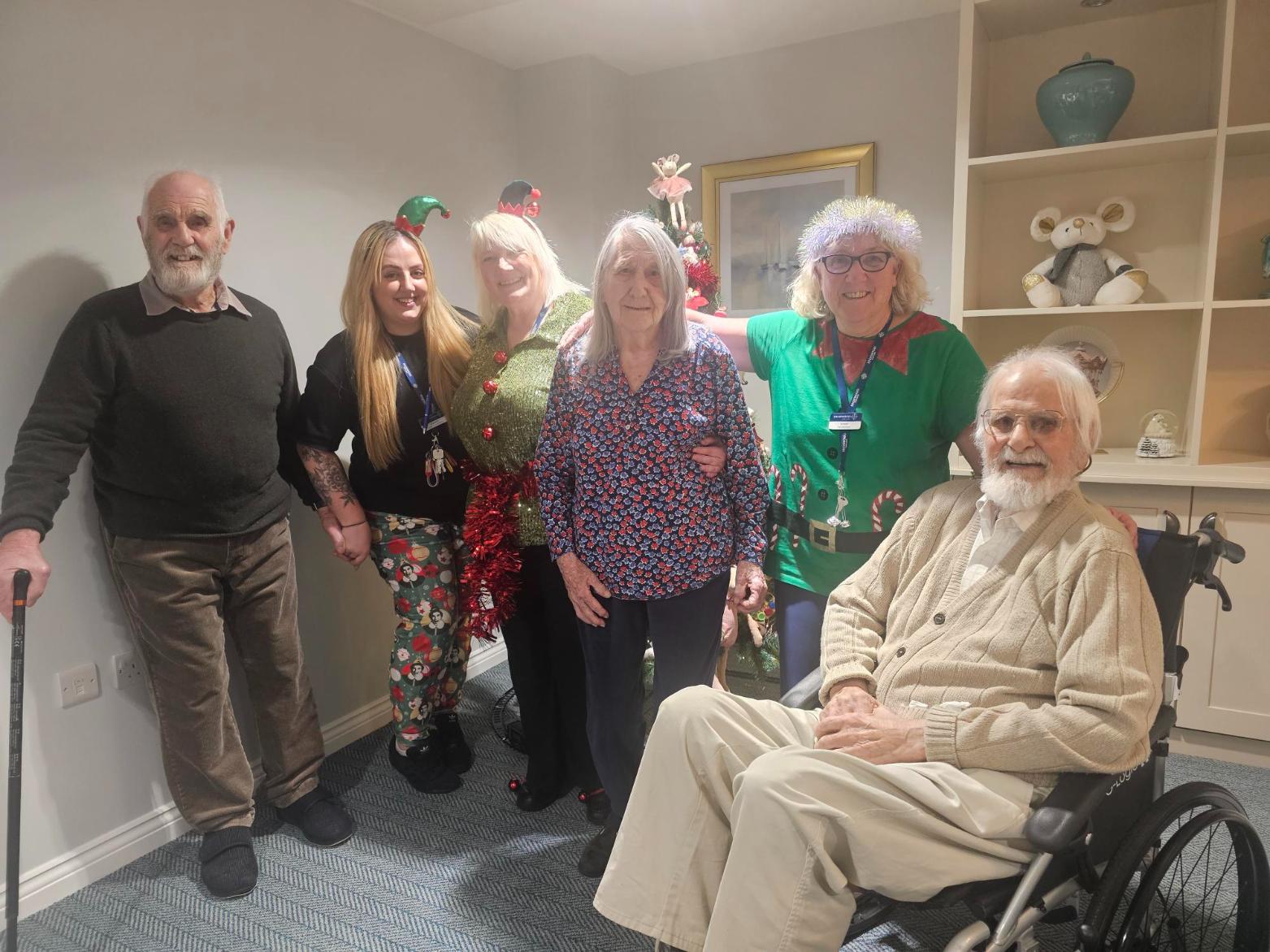 our team and residents dressed up in comfy christmas outfits