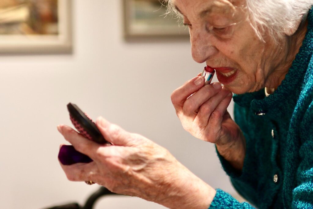 resident applying lipstick