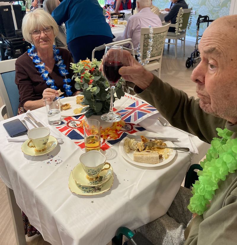 residents enjoying afternoon tea together on decorated tables