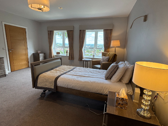 enlarged view of bright and clean bedroom with two windows